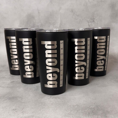 Five matte black insulated tumblers with clear lids arranged in a pyramid on a light gray textured surface. Each tumbler is printed vertically with the words "beyond" in large silver letters, with smaller text reading "TEXTBOOKS" running alongside.