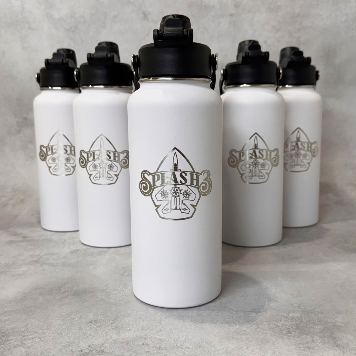 White water bottles arranged in a row engraved with the Splash 3 logo on a gray background. 