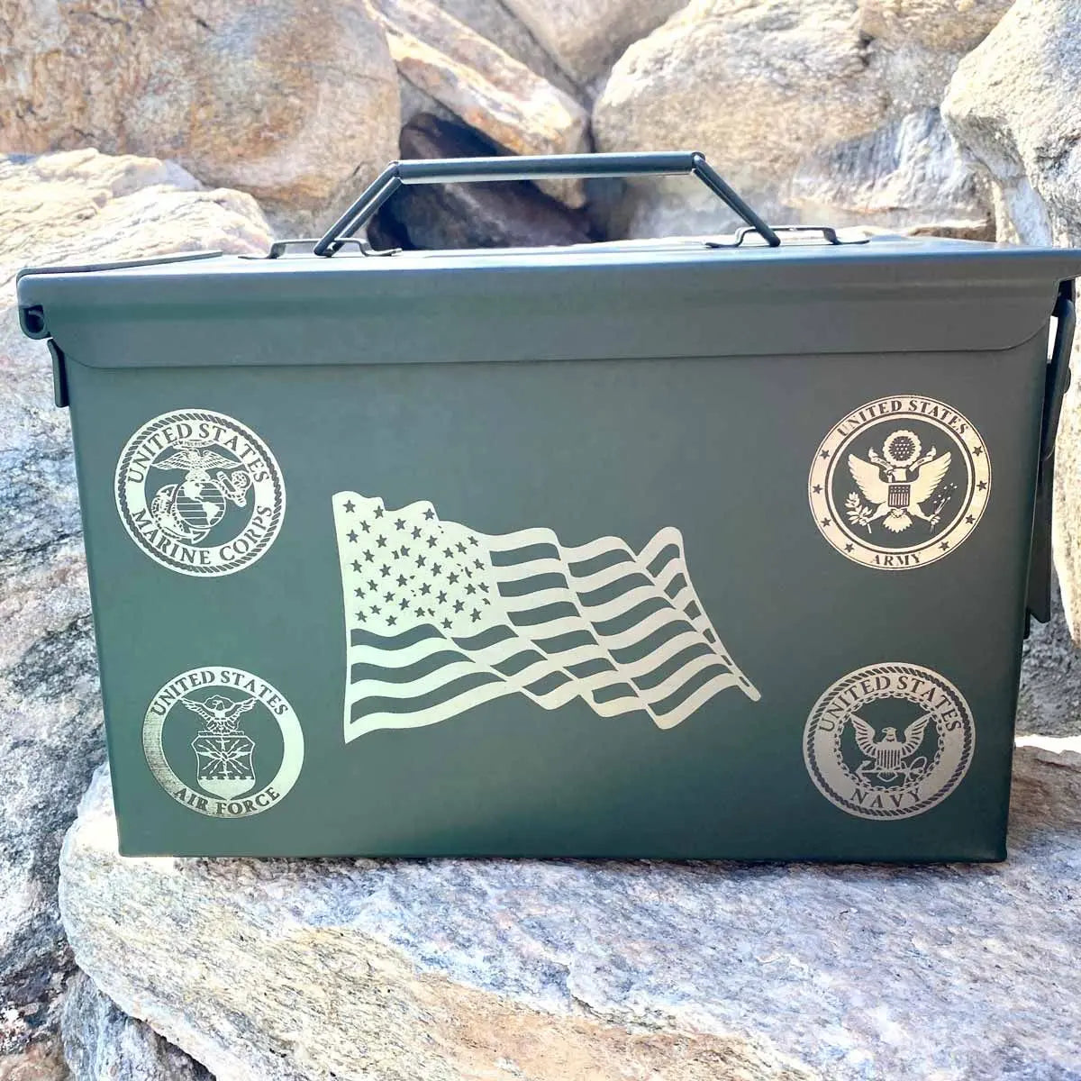 Laser engraved flag on ammo can sitting on rocks.