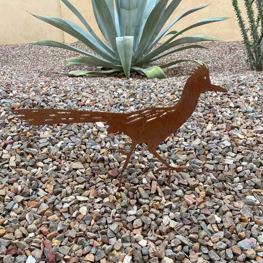 rusted metal roadrunner in the yard