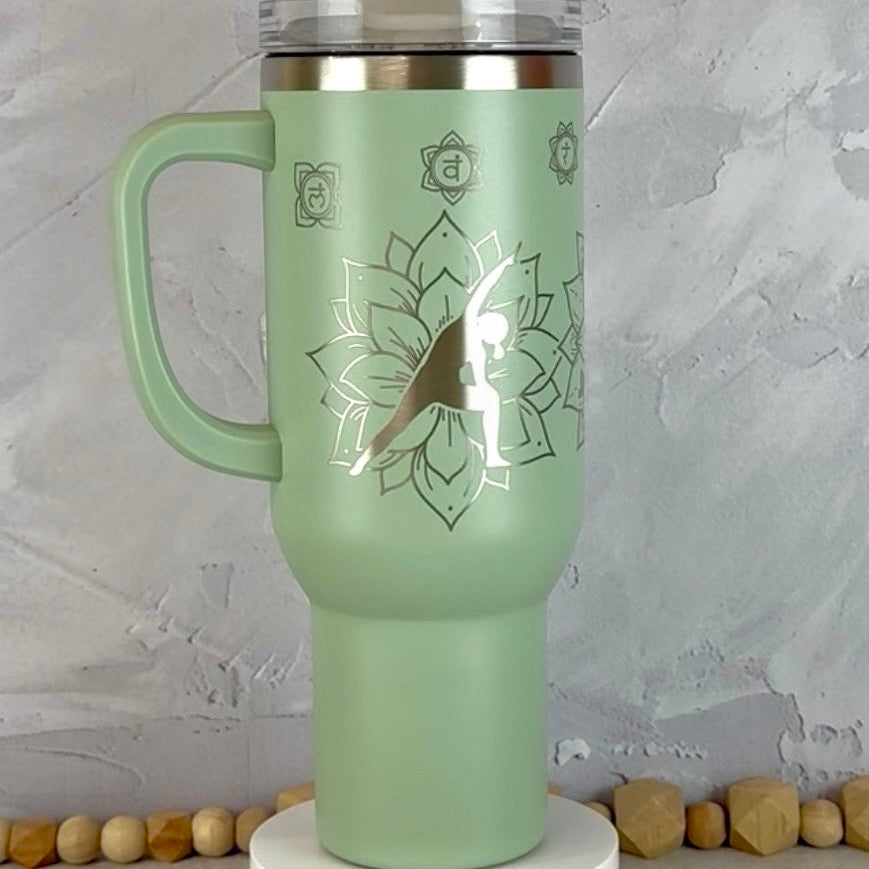 Sage Green 40 oz Tumbler with Side Handle engraved with yoga poses and mandalas.