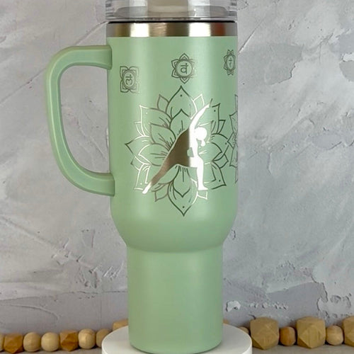 Sage Green 40 oz Tumbler with Side Handle engraved with yoga poses and mandalas.
