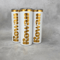 Skinny 20 oz tumbler laser engraved with custom branding, revealing a gold layer underneath