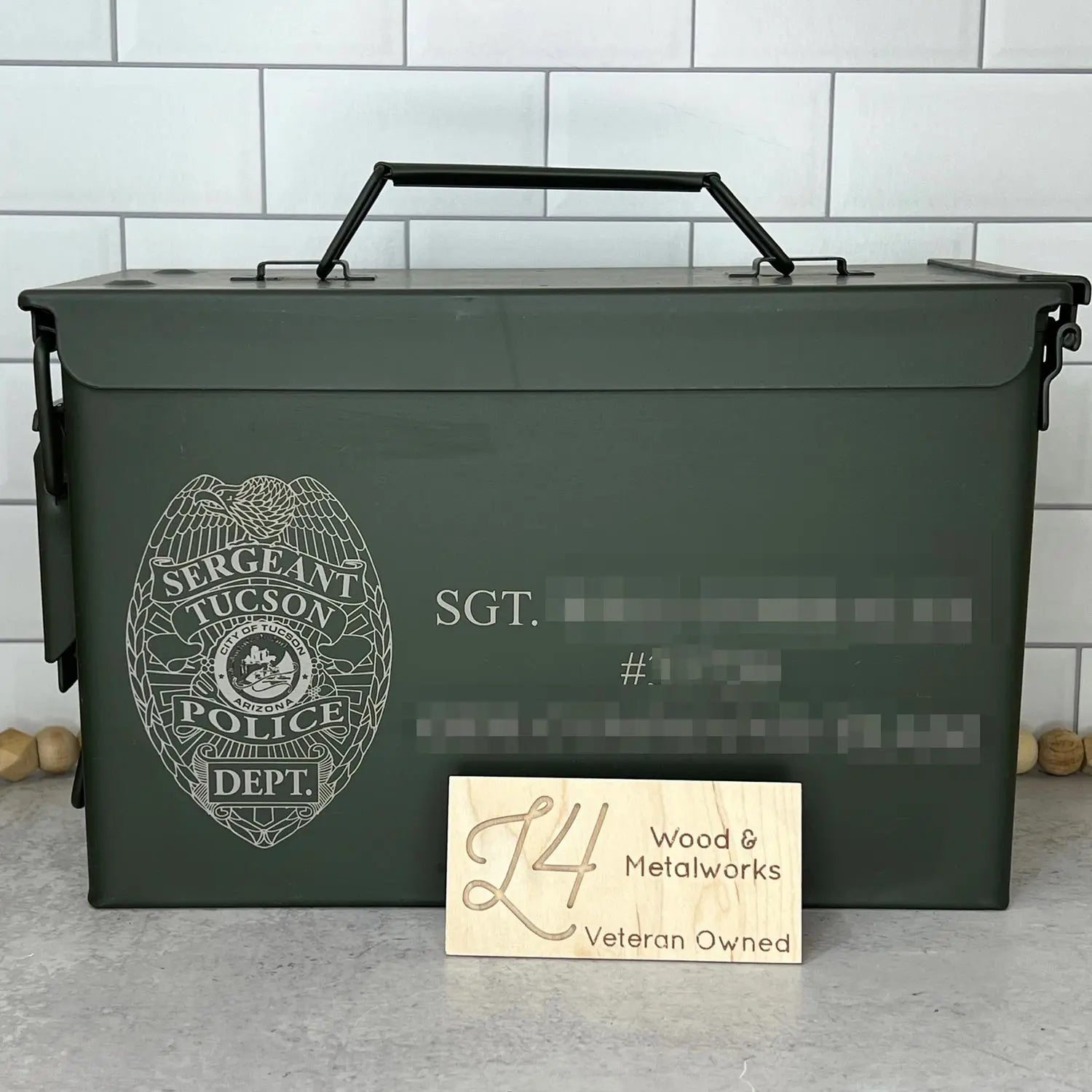 Custom Ammo Box Retirement Gift with recipient name blurred out.