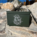 Laser engraved ammo can sitting on rocks.