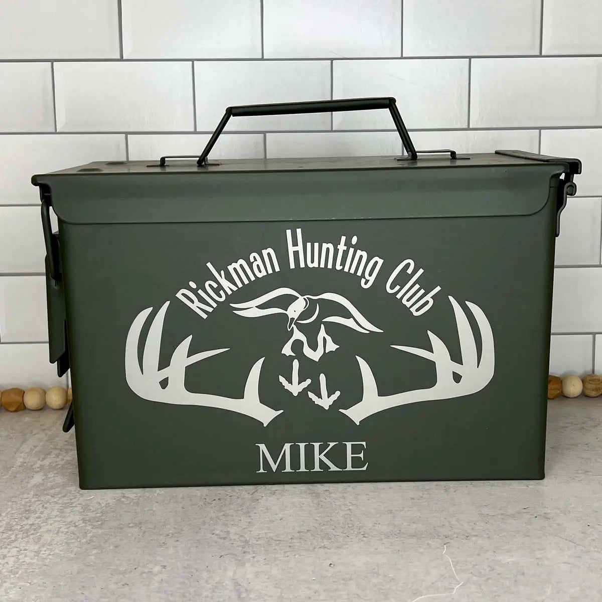 deer antler and name engrave on green ammo can.