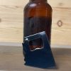 black Arizona bottle opener leaning against a bottle