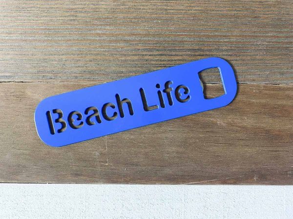 Beach life bottle opener in blue leaned against a bottle