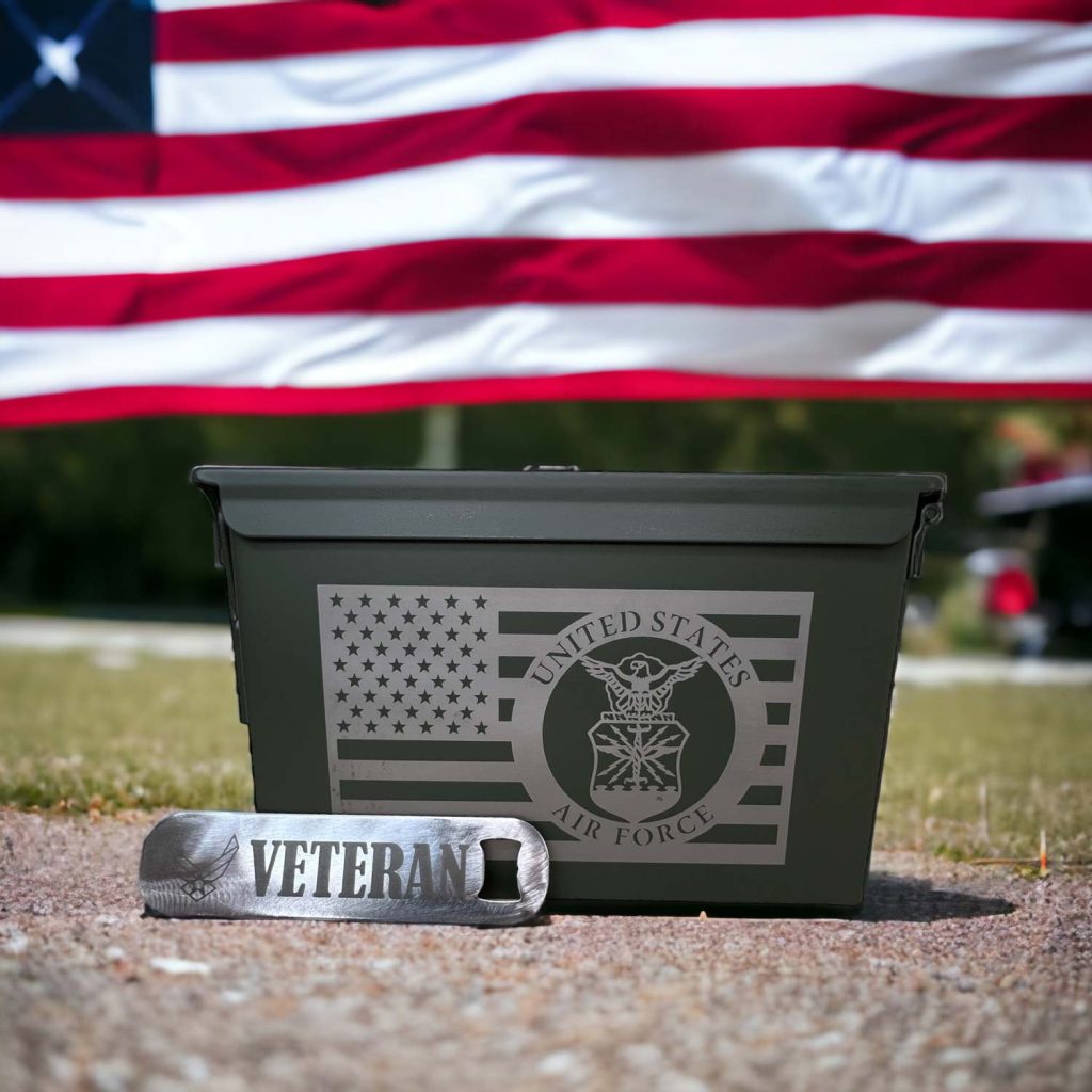 US flag in the background, custom engraved ammo can with Air Force flag and an engraved bottle opener that says Veteran.