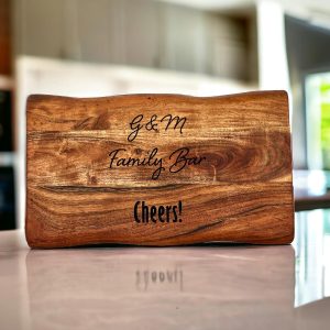 thick cutting board that has been laser engraved. Image is AI enhanced to show it siting on a counter with an out of focus kitchen in the background.