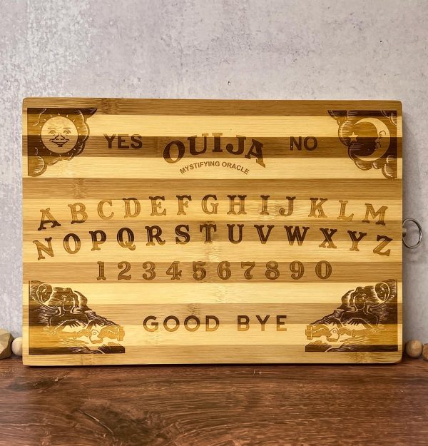 striped wood cutting board engraved with a Ouija board