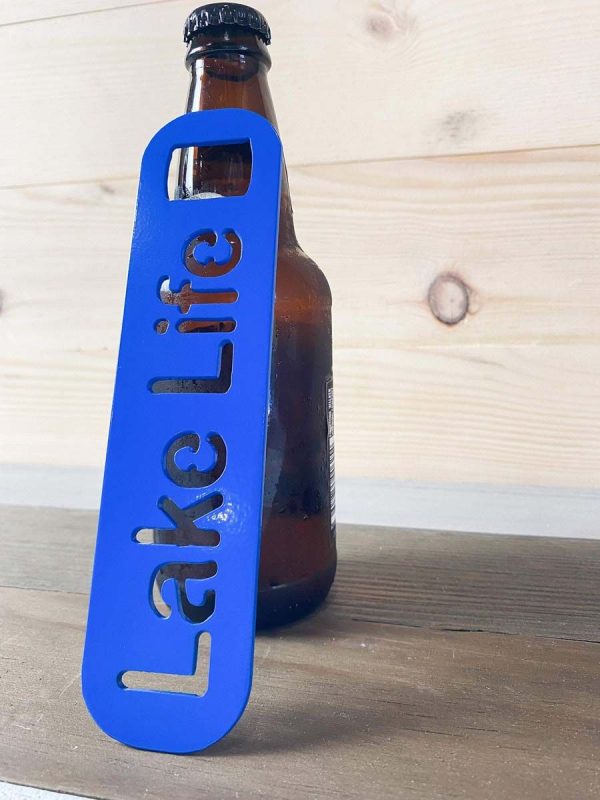 Lake life bottle opener in blue leaned against a bottle