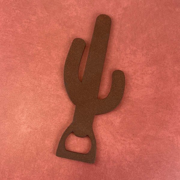 powder coated rust color saguaro shaped bottle opener on a rust colored background