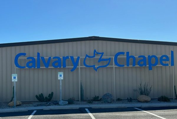 blue calvary chapel sign in front of tan building