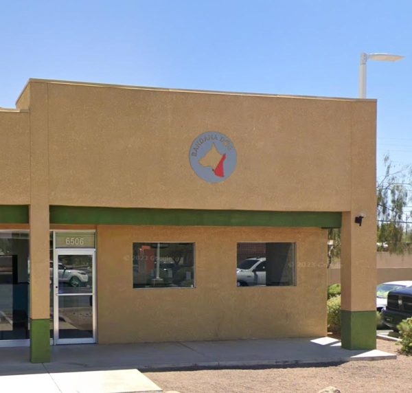large metal sign on the front of a business in tucson, arizona