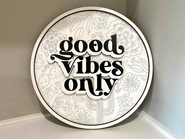 round white sign, says Good Vibes