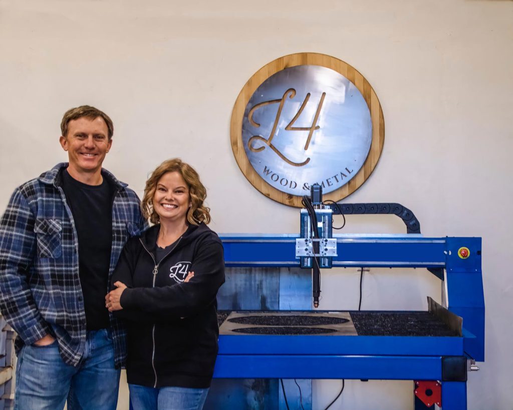 becca and steve in front of the company sign for L4 Laser Engraving and Metal Art