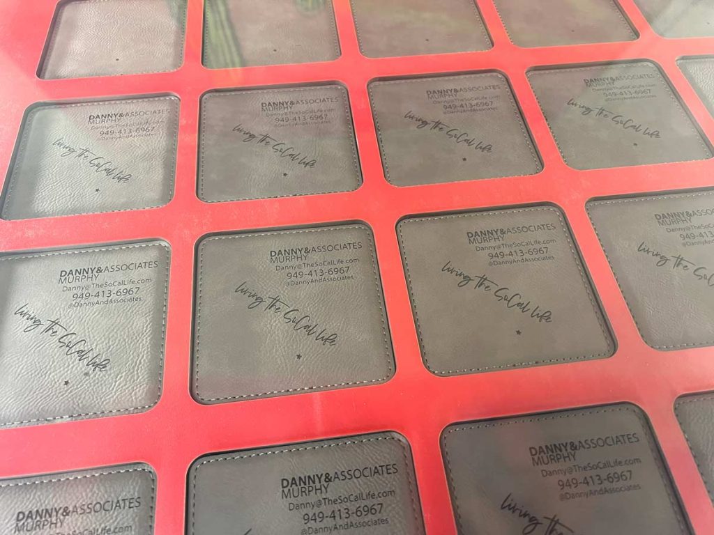 coasters on a spacing jig inside a laser engraver