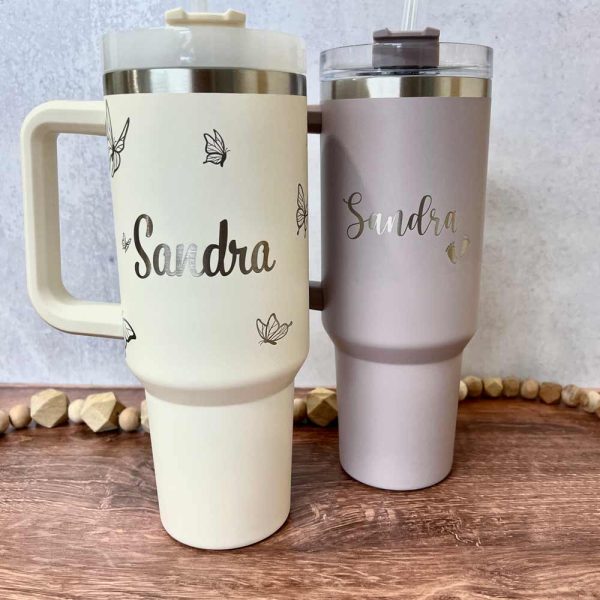 two engraved Stanley tumblers with name Sandra