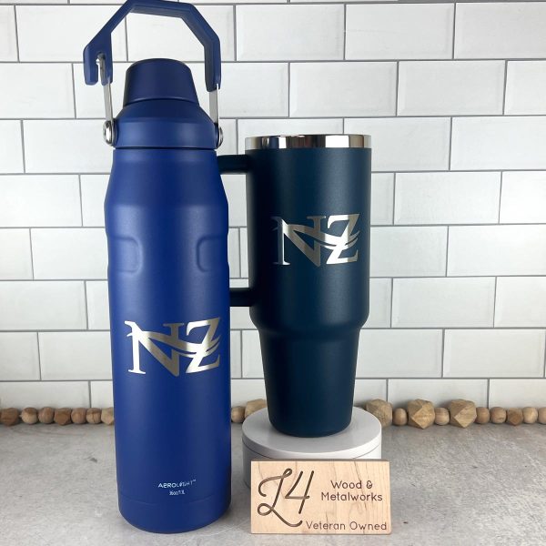 custom engraved blue bottle with logo, next to a blue cup with a handle and logo