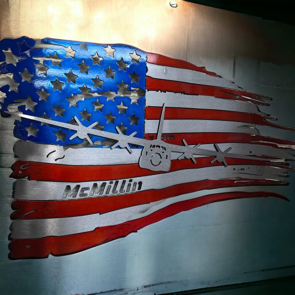 red, silver, and blue tattered metal flag with airplane layered on top and name cut out