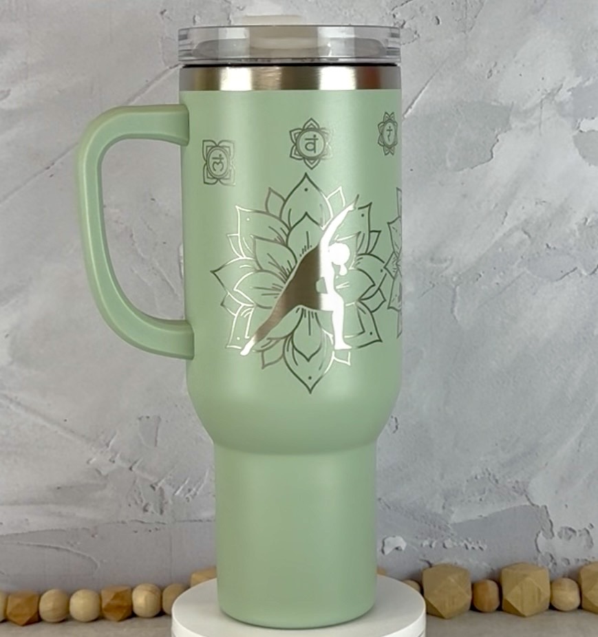 Sage Green 40 oz Tumbler with Side Handle engraved with yoga poses and mandalas.