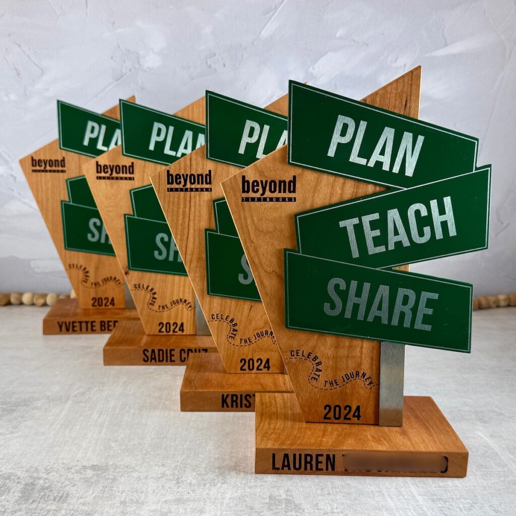 Four wood and metal trophies with custom branding and painting.