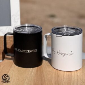 Two 12 oz Engraved Coffee Mugs for wedding. Black and white mugs on top of a cutting board.